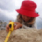 Nature Explorer child at the sand dunes with measuring tape
