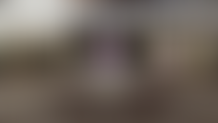 Digital render of Clara's TARDIS set. This shot depicts the white control console on its hexagonal wooden platform. The diner entrance with its blue and pink neon lights is visible in the background. Beside the console a pink holographic screen sits on a wheeled metal frame like a blackboard.