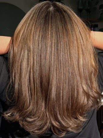 Dimensional brunette balayage with soft highlights and long layered haircut