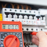 Electrician Measuring Voltage with Multimeter in Circuit Breaker Panel.jpg