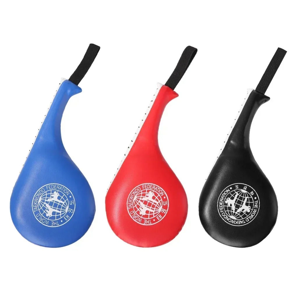 Three martial arts kicking pads: blue, red, and black