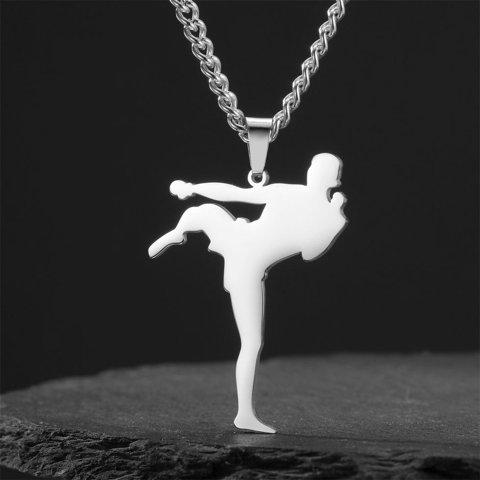 Miniature : Silver pendant with figure in high kick pose