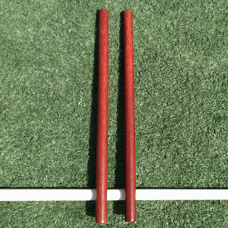 Miniature : Two red poles standing vertically on green turf