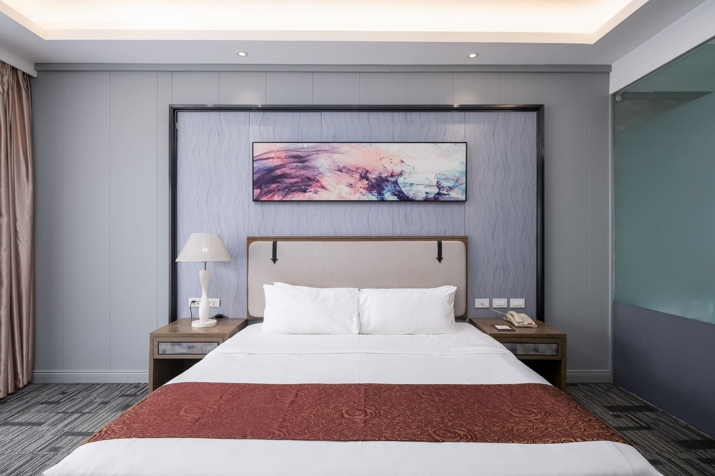 A photo of the bed in a Standard King room in Sunlight Hotel Puerto Princesa