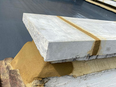 A detailed shot of a coping stone with sand and cement