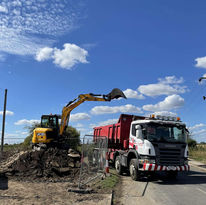 waste from digger into truck