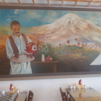 Man pouring tea in mountains wall art 