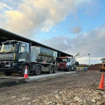 Mixing trucks on building site