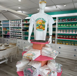 T-shirt display in front of product shelves inside store