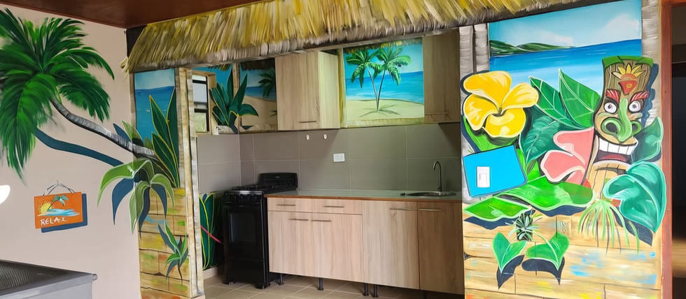 Hand-painted tiki mural with tropical elements and vibrant colors