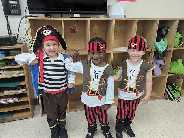 Three school aged boys dressed as pirates for learning time at Buidling Futures