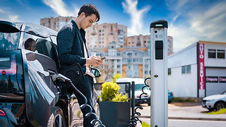 man-charging-his-electric-car-charge-station-using-smartphone-Gulu-Electrical-Contractors.