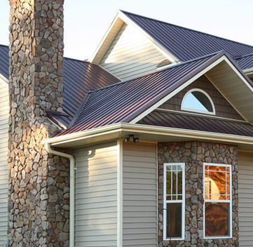 Modern metal roof with stone masonry chimney