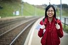 Asian girl travelling in swiss station.png