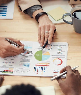 Team collaborating on sales strategies with data charts, analyzing reports for tailored sales process development and growth