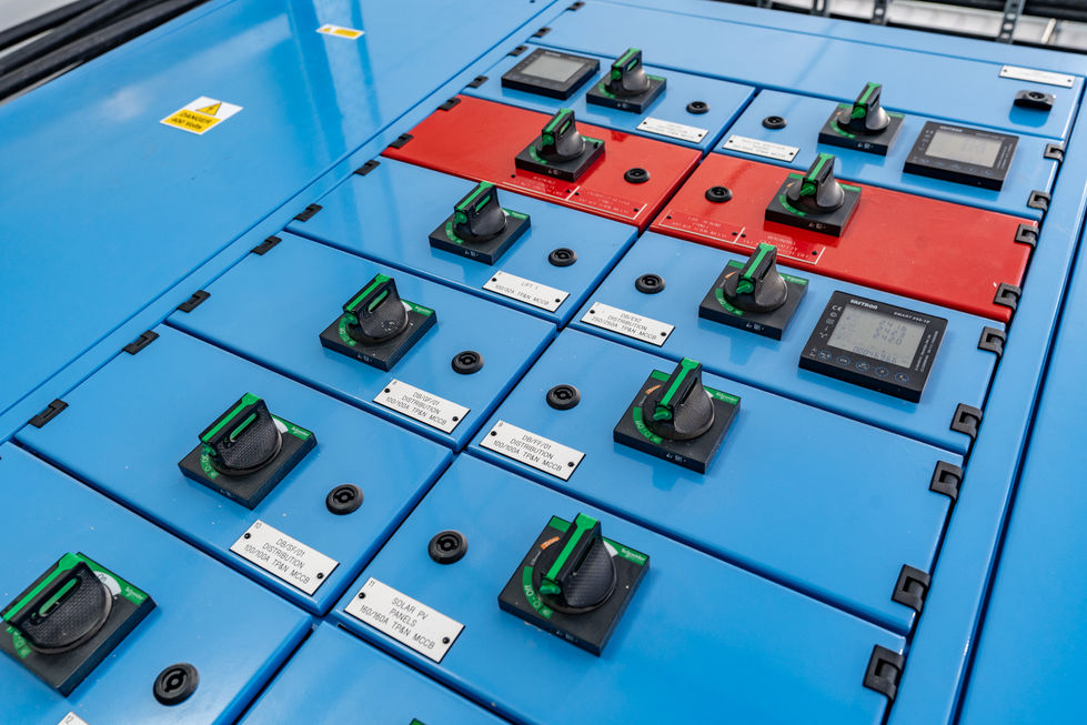 Close-up of electrical switch controls on blue distribution panel