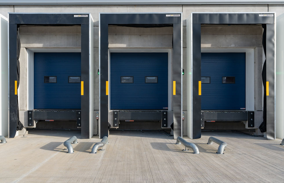 Close-up view of warehouse loading dock bays with dock levellers and bumpers