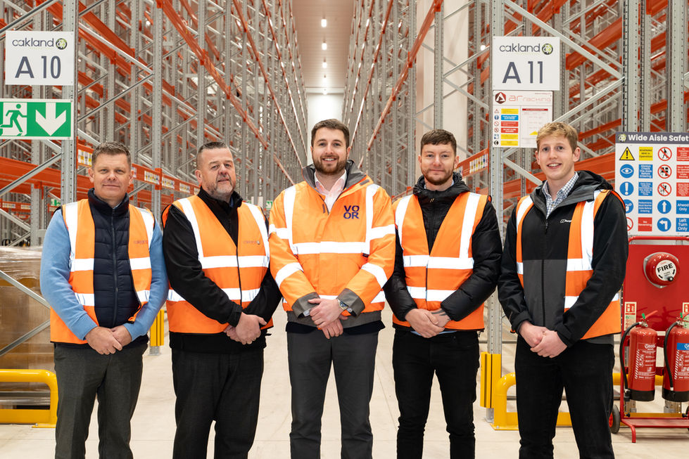 Internal view of installed pallet racking within the warehouse, showing high bay storage, aisle signage, safety protection and the operational layout of the storage area.