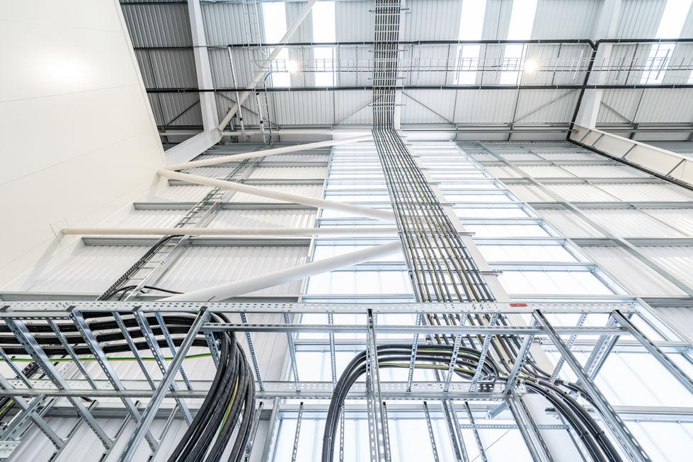 Vertical cable containment and structural bracing inside warehouse building