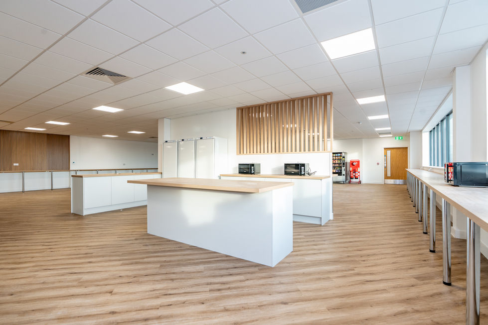 Modern staff breakout area with timber flooring, kitchen and open seating space