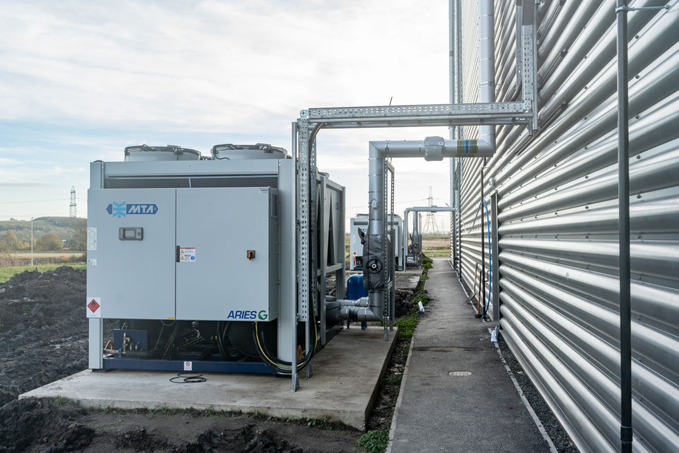 External plant and service pipework installation beside warehouse building