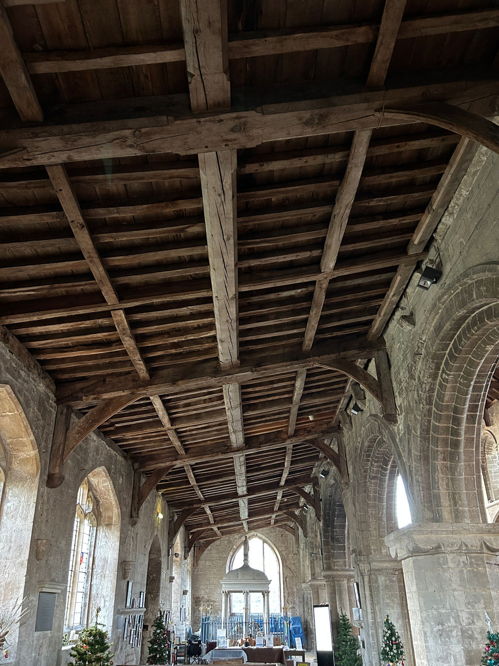 Interior view of St Mary’s Church, Whaplode, showing the historic timber aisle roof structure and stone arcade