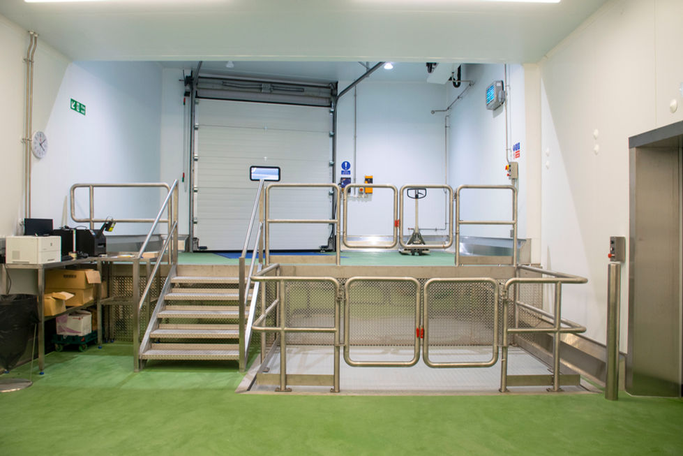 Loading bay and internal dispatch platform at Associated Seafood facility with stainless steel safety rails