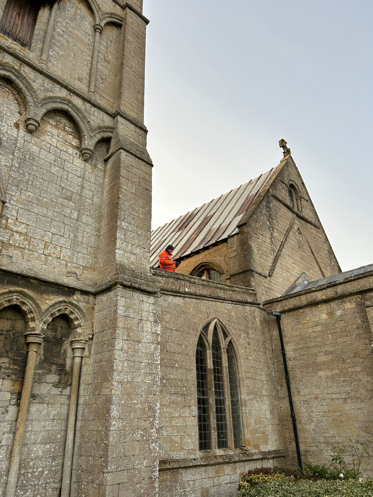Alt text: External view of St Mary’s Church, Whaplode, showing roof level survey access beside the tower and nave roof