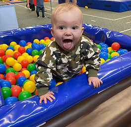 Small child playing in a ball pit