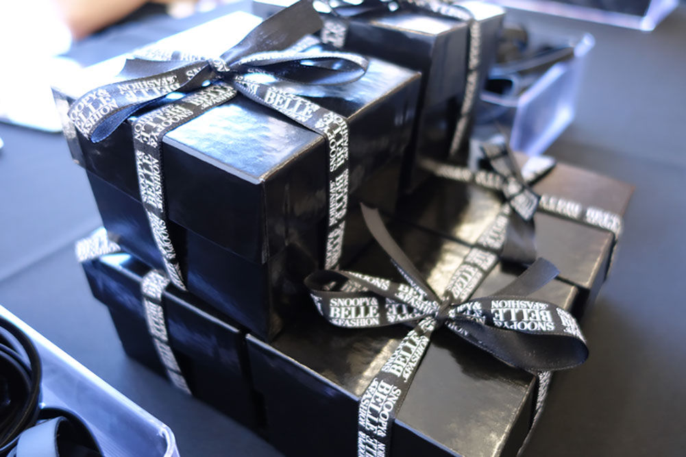 black boxes wrapped in ribbon