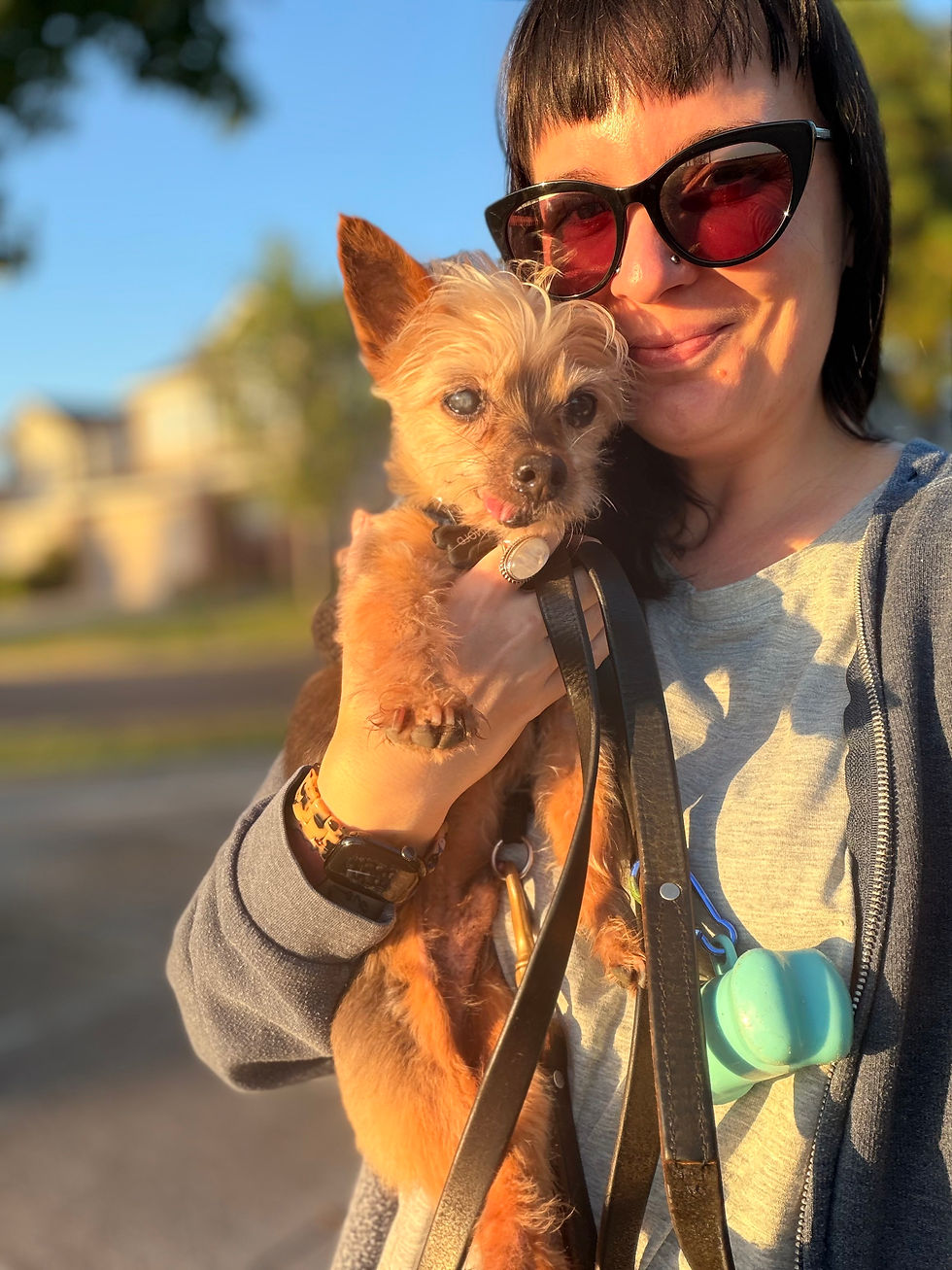 Kim, the pet bestie holding a senior Yorkie dog