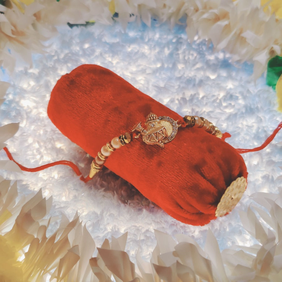 Thumbnail: Designer Kalash Pendant Rakhi with Pearl Beads