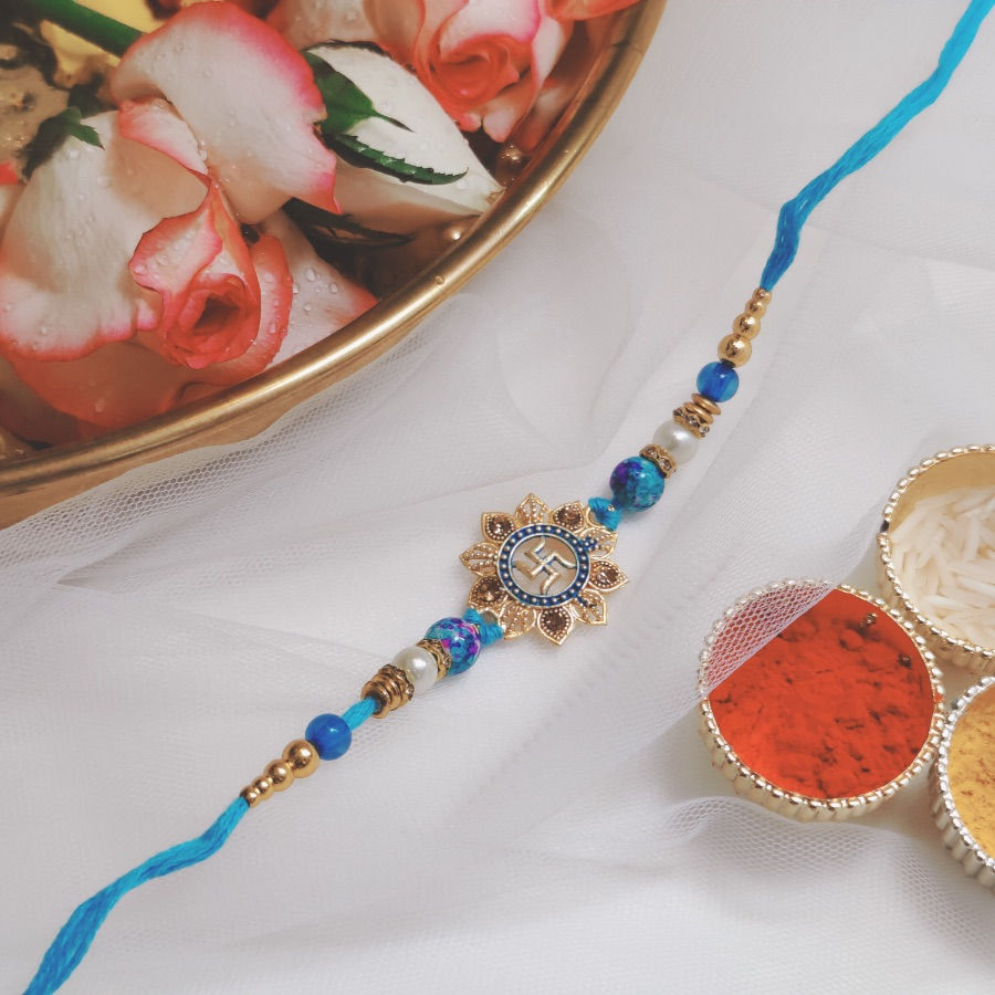 Swastik Pendant Rakhi with Blue & White Pearl Beads