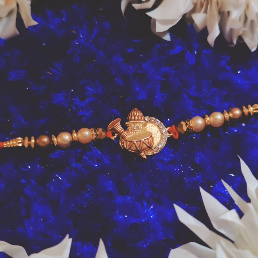 Thumbnail: Designer Kalash Pendant Rakhi with Pearl Beads