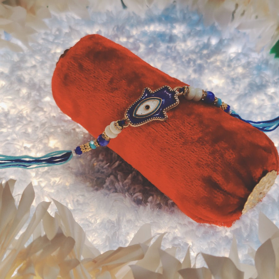 Thumbnail: Evil Eye Charm Rakhi with Pearl Beads