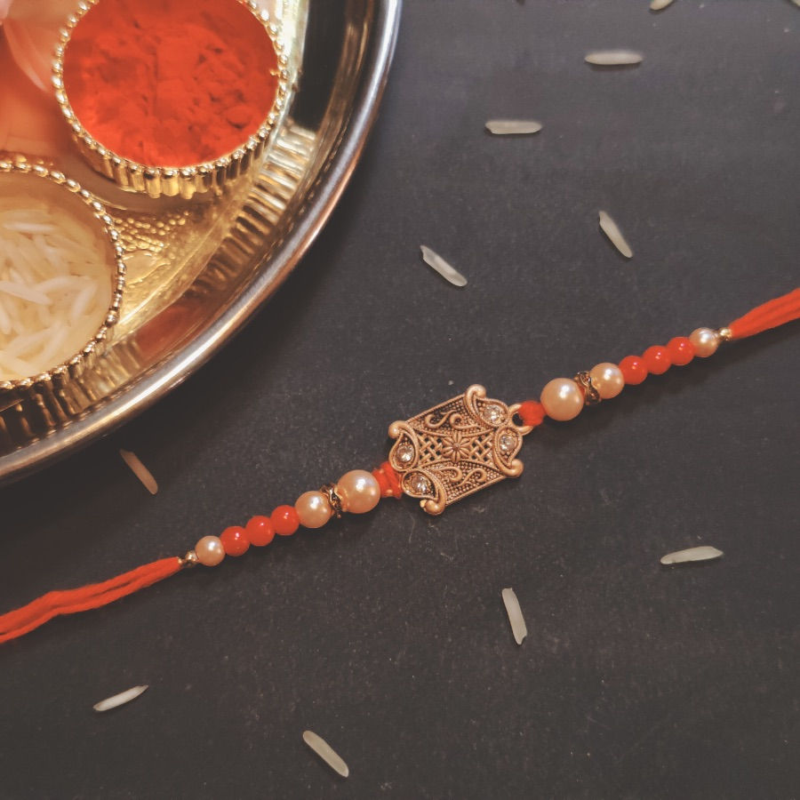 Traditional Pendant Rakhi with Red & White Pearl Beads