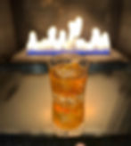Old fashioned drink in front on a fireplace