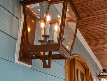 Elegant large copper sconce on the exterior of a custom-built home in Newport, NC, showcasing premium craftsmanship and coastal design by custom home builder near Morehead City, NC. 