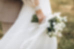 Close-up wedding couple bride and groom walk hand in hand through a pine forest, sunlight