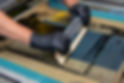 hand made screen printing, squeezing the paint with a squeegee.jpg