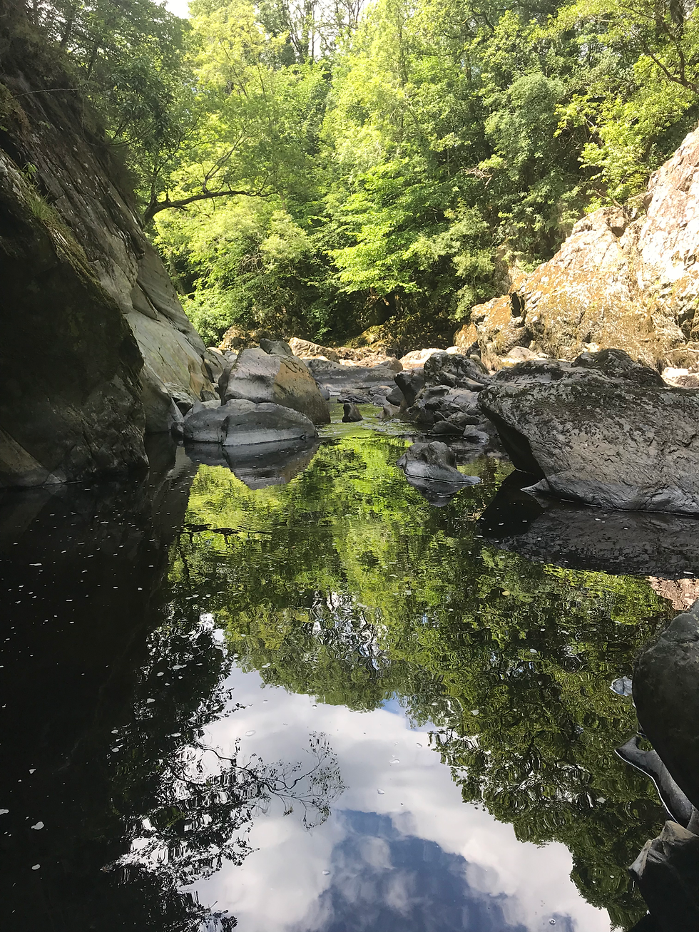 river gorge in Wales with the reflection of the sky in the water