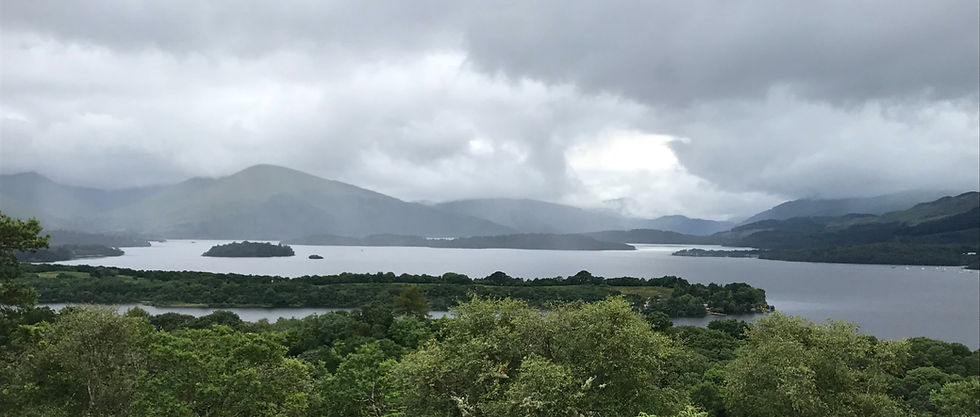Loch Lomond with few of clouds and hills on the other shore