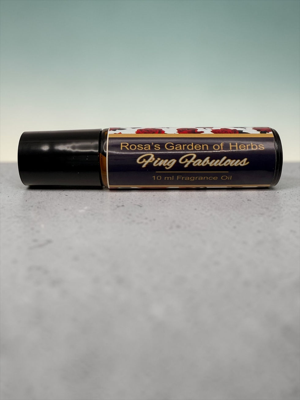 Thumbnail: F’ing Fabulous fragrance oil roller 10 ml bottle on gray surface with teal background