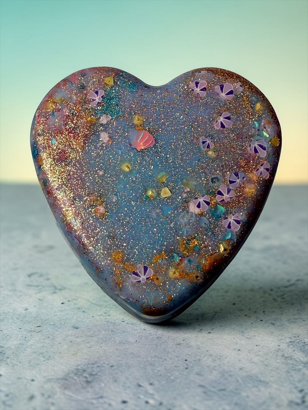 Blue Lava Lagoon glitter heart wax melt with gold shimmer on pastel background