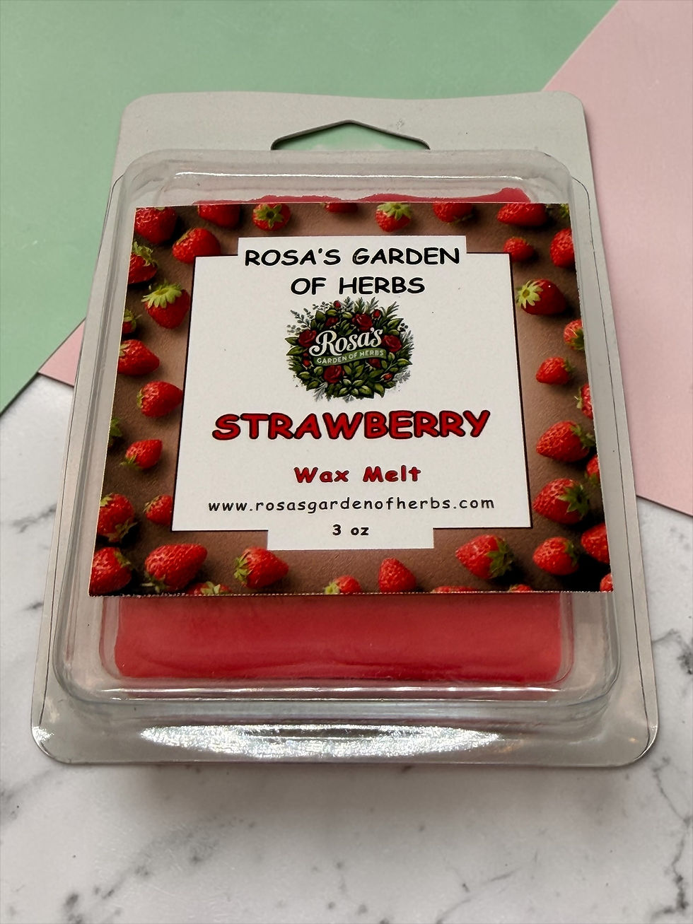 Strawberry wax melts 3 oz clamshell with strawberry label on pink and white background