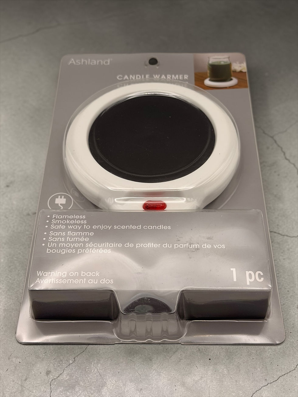 Electric candle warmer hot plate in retail packaging on white background