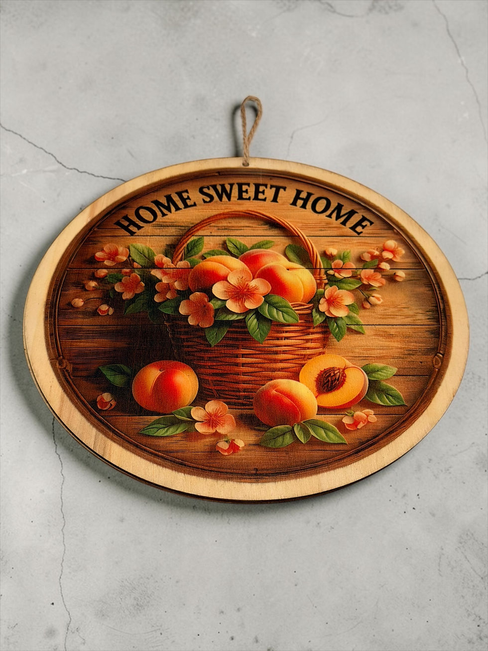 Thumbnail: Round “Home Sweet Home” wooden wall sign with peach basket on rustic table