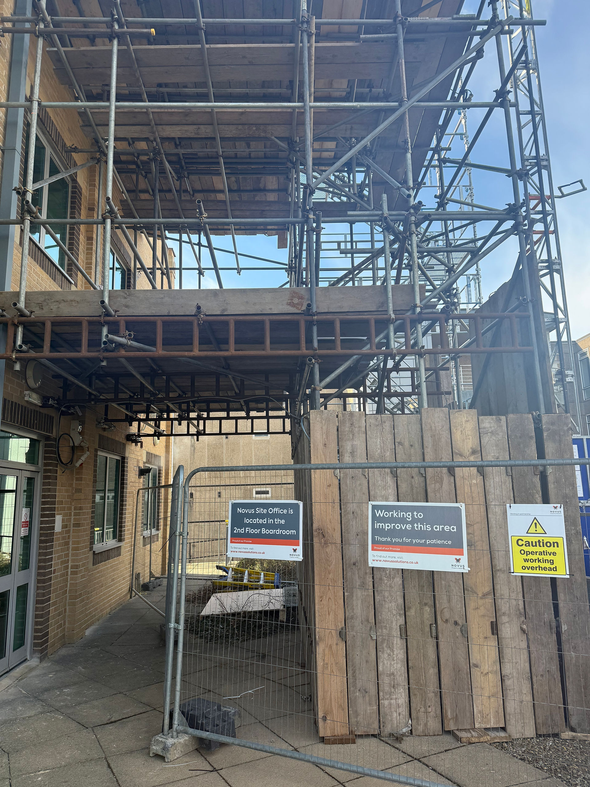 Walkthrough scaffold design allowing safe fire escape access beneath structure at University of York while ground floor remained operational