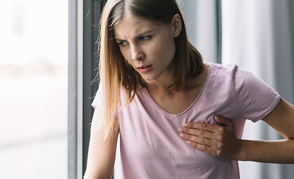 portrait-young-woman-touching-her-chest-