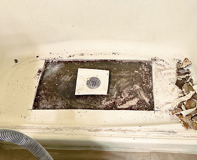 Damaged fiberglass shower floor opened for structural repair